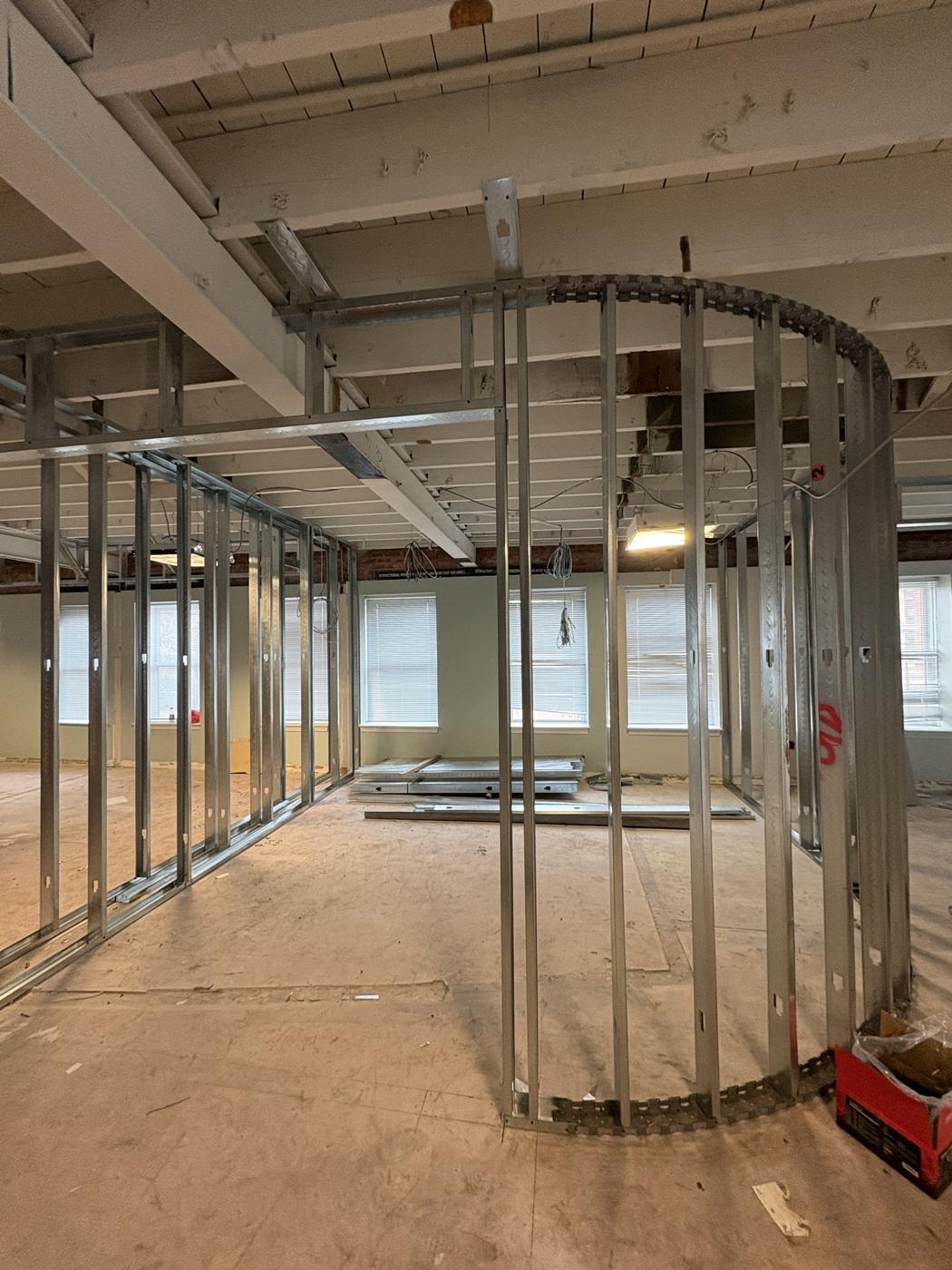 Curved steel stud wall framing in an open office floor