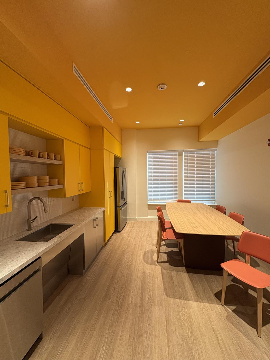 Kitchen and café with yellow ceiling and cabinets